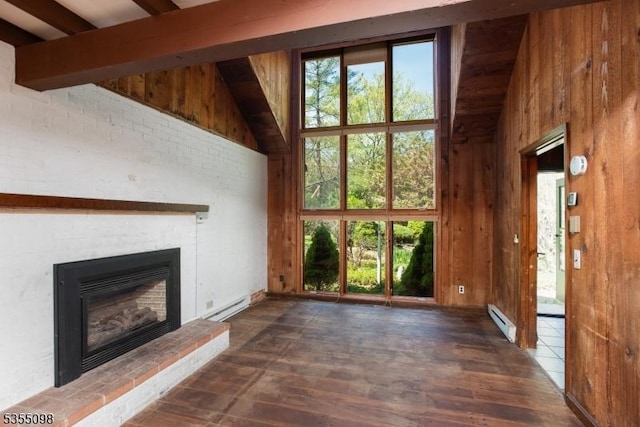 22 Pine Hill Rd, Delaware Twp, NJ 08559 - unfurnished living room featuring a baseboard radiator, baseboard heating, wood walls, a glass covered fireplace, and healthy amount of natural light