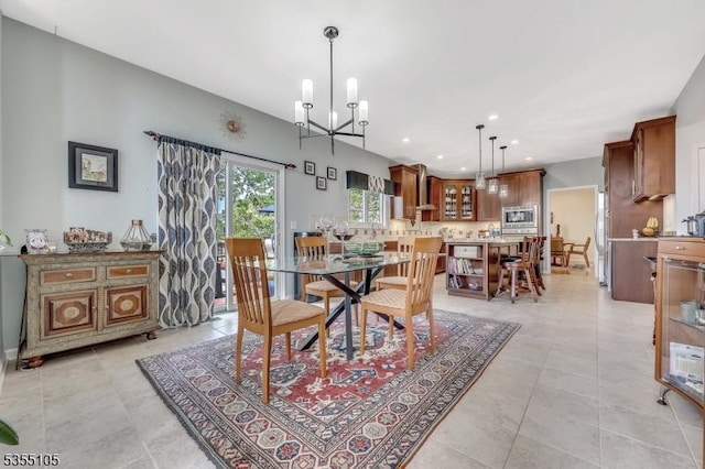 dining area with recessed lighting, light tile patterned floors, and a notable chandelier