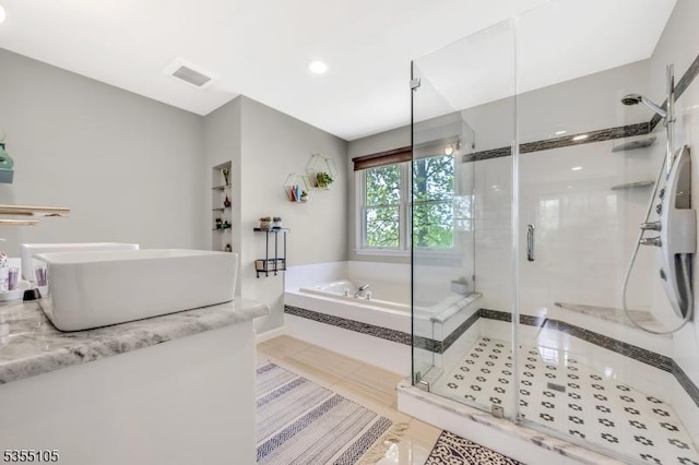 bathroom with visible vents, vanity, a garden tub, tile patterned floors, and a shower stall