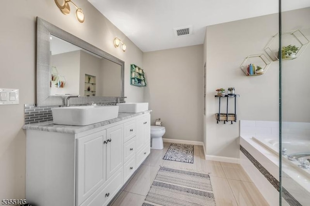 full bath featuring a sink, double vanity, toilet, tasteful backsplash, and visible vents