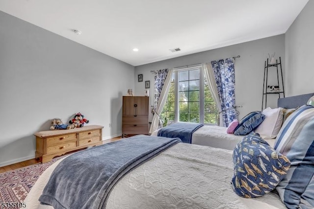 bedroom featuring baseboards, recessed lighting, wood finished floors, and visible vents