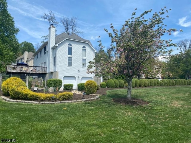 view of property exterior featuring a lawn, a chimney, and a garage