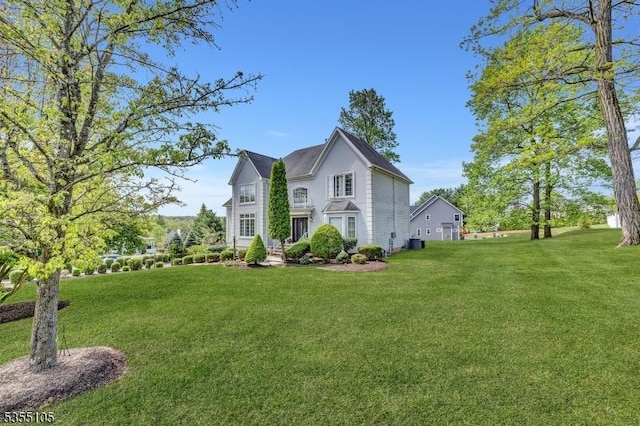 exterior space with a yard and central AC