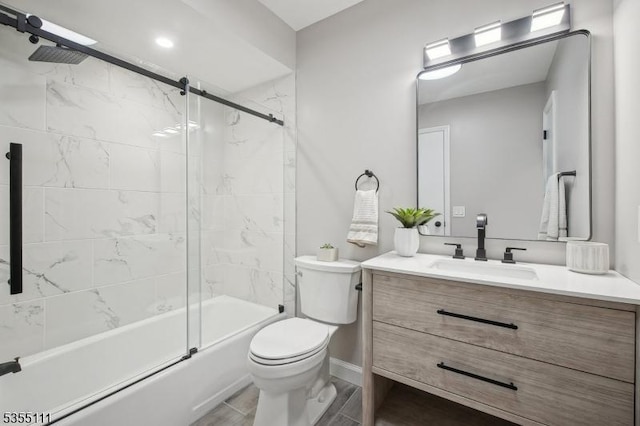 full bath featuring toilet, vanity, shower / bath combination with glass door, and baseboards