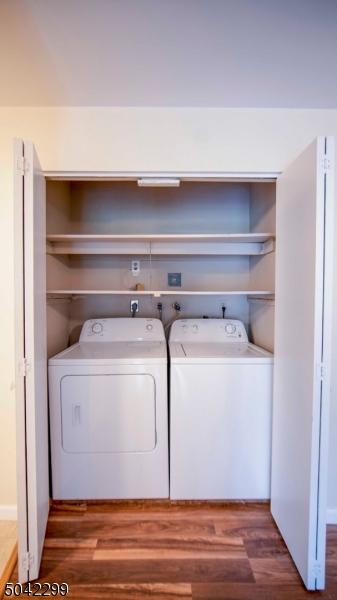 washroom with laundry area, dark wood-style flooring, and washer and dryer