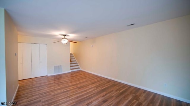 unfurnished room with baseboards, a ceiling fan, wood finished floors, and visible vents