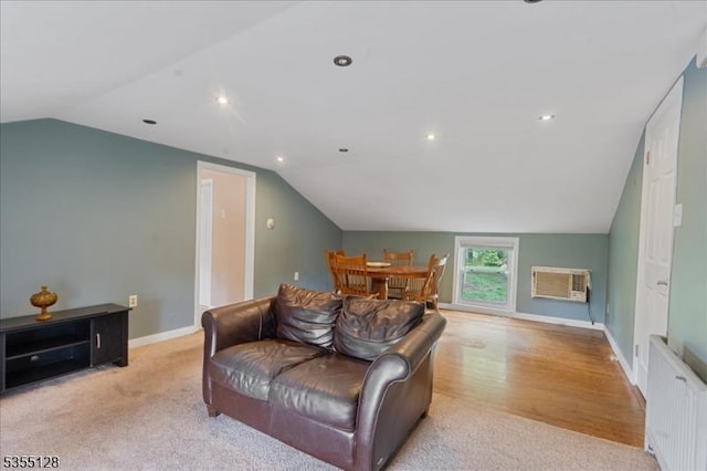 carpeted living area with vaulted ceiling, a wall unit AC, radiator heating unit, baseboards, and recessed lighting