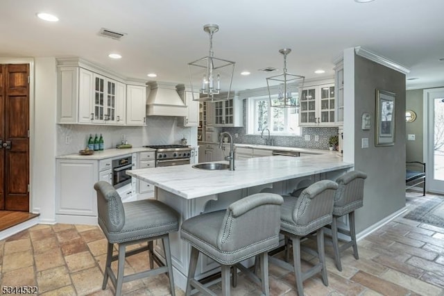 1251 Rahway Rd, Scotch Plains Twp, NJ 07076 - kitchen featuring a kitchen bar, visible vents, a sink, custom exhaust hood, and stainless steel appliances