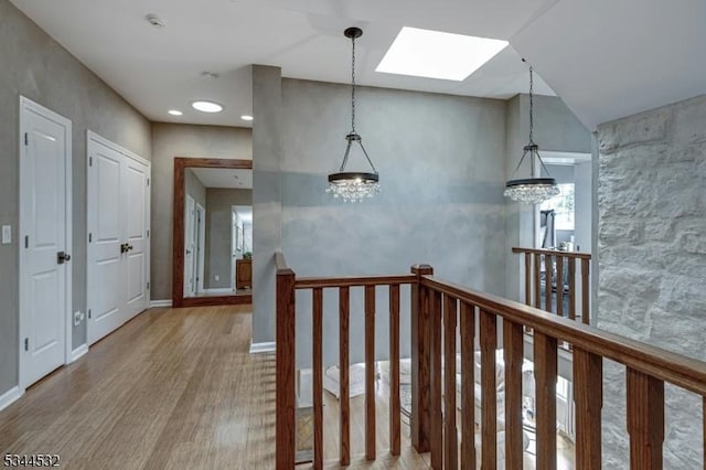 1251 Rahway Rd, Scotch Plains Twp, NJ 07076 - hallway featuring a skylight, an upstairs landing, wood finished floors, a chandelier, and recessed lighting