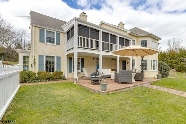 1251 Rahway Rd, Scotch Plains Twp, NJ 07076 - back of property featuring stucco siding, a chimney, an outdoor living space, a patio area, and a lawn