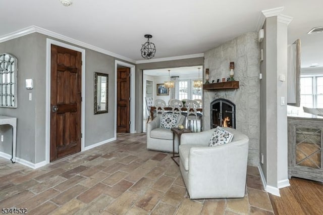 1251 Rahway Rd, Scotch Plains Twp, NJ 07076 - living room featuring a fireplace, a chandelier, baseboards, visible vents, and ornamental molding
