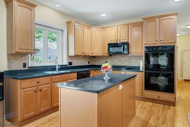 63 Twin Oaks Rd, Bridgewater Twp, NJ 08807 - kitchen with dark countertops, light wood-type flooring, black appliances, and a sink