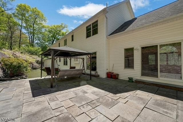 63 Twin Oaks Rd, Bridgewater Twp, NJ 08807 - rear view of property featuring a shingled roof, a patio, and a gazebo