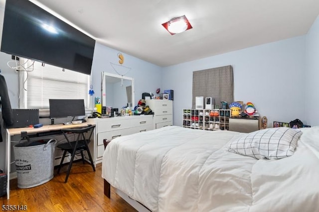bedroom featuring wood finished floors