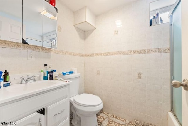 full bath featuring tile patterned flooring, vanity, toilet, tile walls, and a shower with door