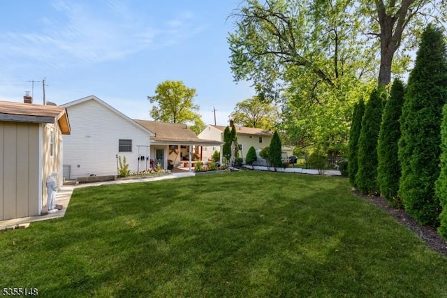 rear view of property with a yard