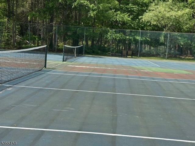 view of sport court featuring fence