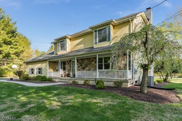 view of front of home featuring a porch, a front lawn, a chimney, and cooling unit