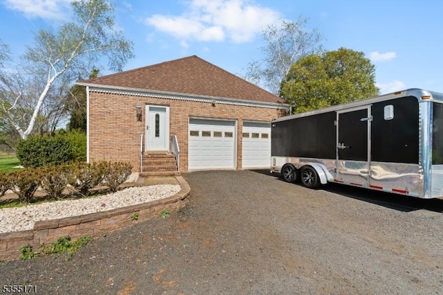 581 Montgomery Rd, Hillsborough Twp, NJ 08844 - view of property exterior featuring roof with shingles, an attached garage, aphalt driveway, brick siding, and entry steps