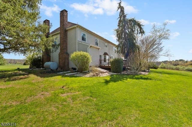 581 Montgomery Rd, Hillsborough Twp, NJ 08844 - back of property with a yard, a chimney, and a wooden deck