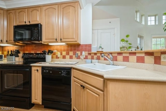 kitchen with a sink, tasteful backsplash, black appliances, light countertops, and light brown cabinetry