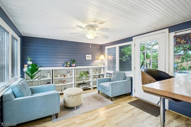 sunroom / solarium featuring wood finished floors