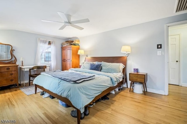bedroom with light wood-type flooring, ceiling fan, and baseboards