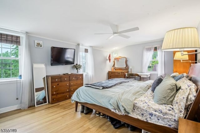 bedroom featuring light wood-style flooring, a ceiling fan, lofted ceiling, and baseboards