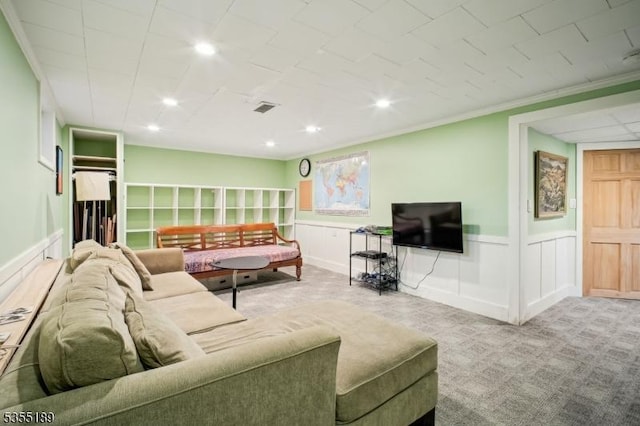 living room with wainscoting, recessed lighting, carpet flooring, and a decorative wall