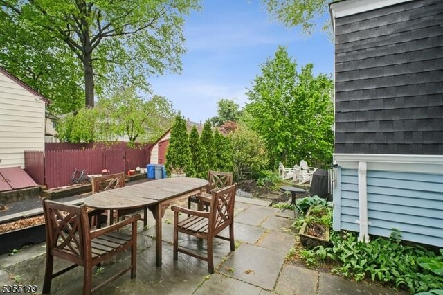 view of patio / terrace with outdoor dining area and fence