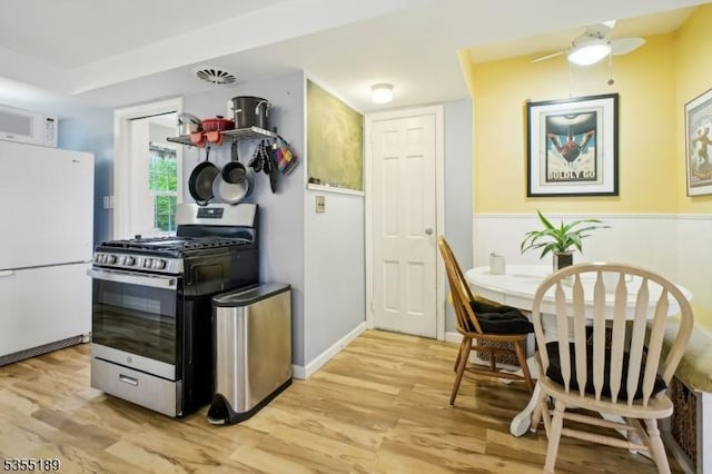 kitchen featuring white appliances and light wood-type flooring