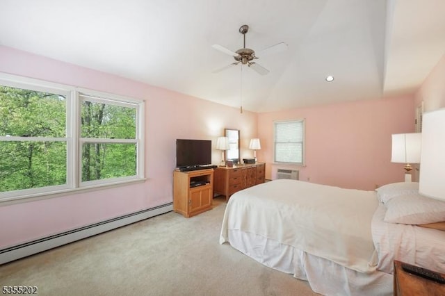 bedroom with vaulted ceiling, multiple windows, baseboard heating, and light carpet