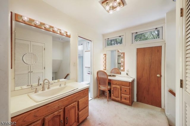 bathroom with a closet, a sink, and two vanities