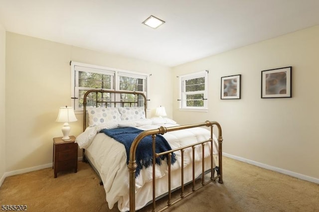 carpeted bedroom featuring baseboards