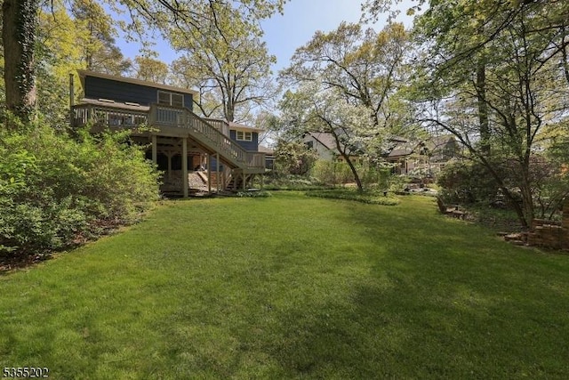 view of yard featuring stairway and a wooden deck