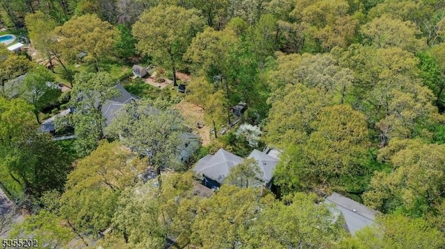 birds eye view of property with a view of trees