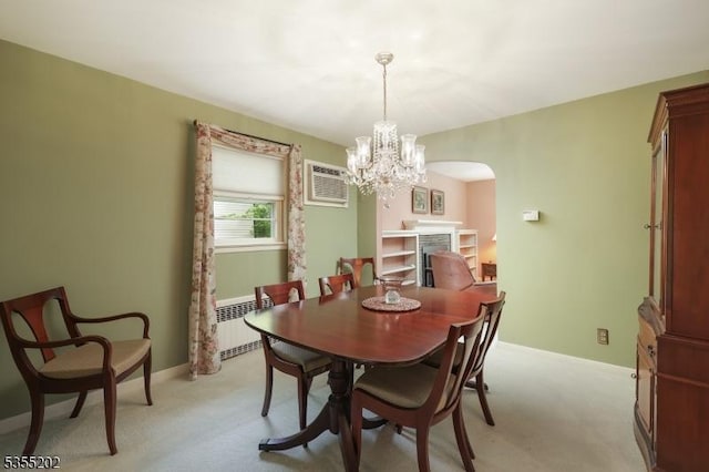 dining space featuring arched walkways, a wall mounted AC, light carpet, and radiator heating unit