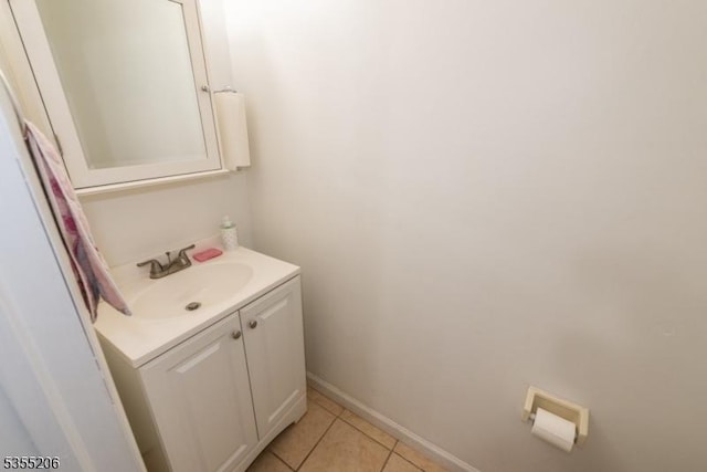 bathroom with tile patterned floors, baseboards, and vanity