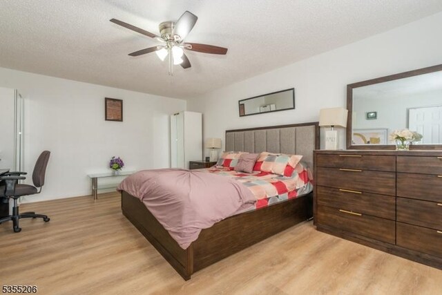 bedroom with a ceiling fan and light wood-style flooring