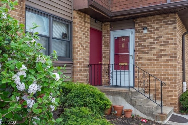 view of exterior entry with brick siding