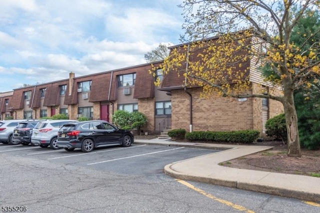 view of property with uncovered parking