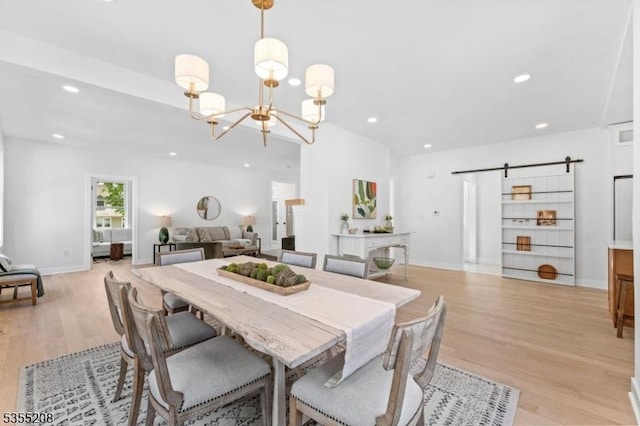 dining area featuring light wood-type flooring, recessed lighting, and a chandelier