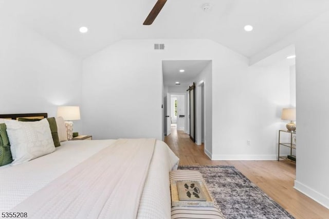bedroom featuring recessed lighting, baseboards, lofted ceiling, and wood finished floors