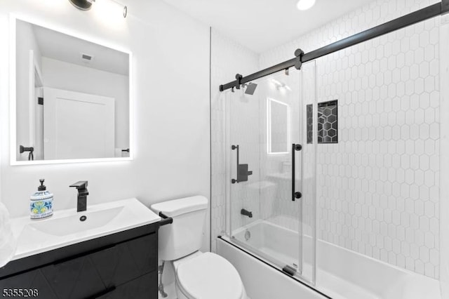 bathroom with vanity, combined bath / shower with glass door, and toilet