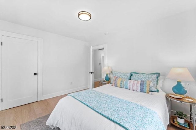 bedroom with light wood-style floors and baseboards