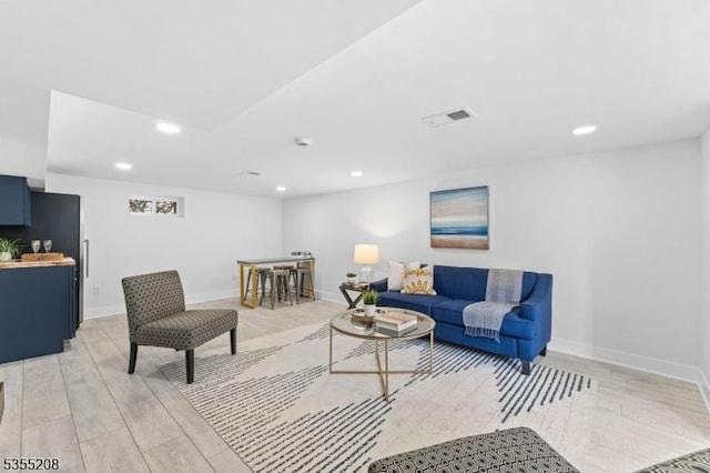 living area featuring recessed lighting, light wood-style flooring, baseboards, and visible vents