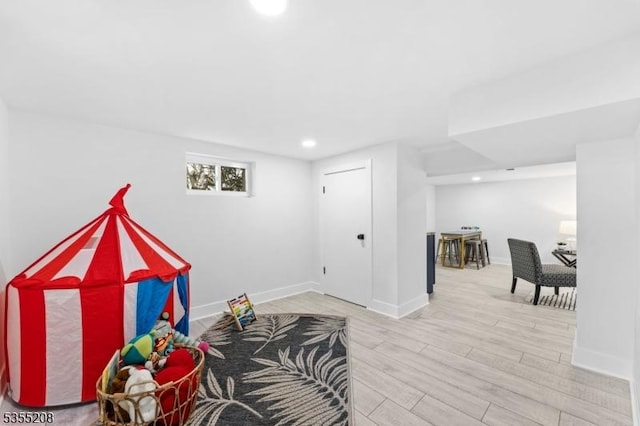 rec room featuring recessed lighting, baseboards, and wood finished floors