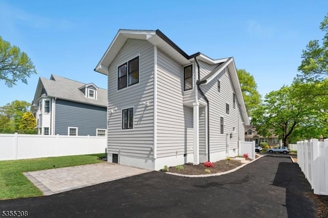 view of property exterior featuring a patio, fence, and a yard