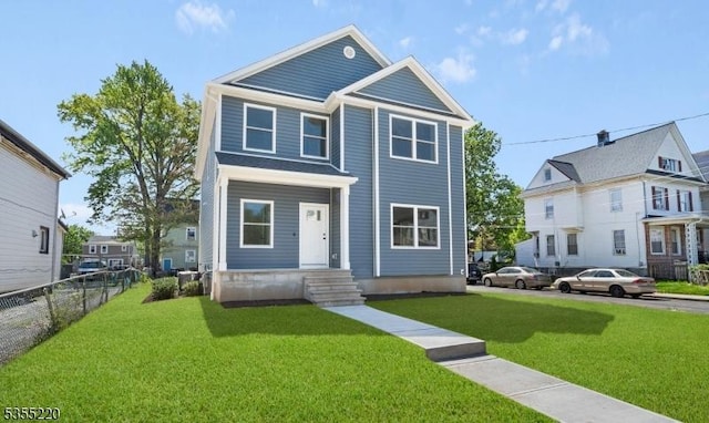 view of front of house featuring a front lawn and fence