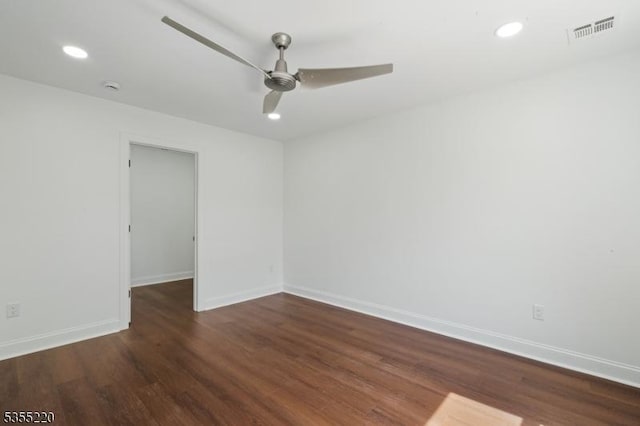 empty room with a ceiling fan, baseboards, visible vents, and wood finished floors